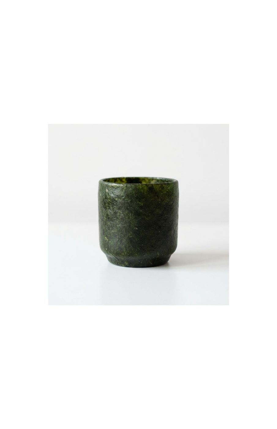 A single dark green seaweed vessel with a clean cylindrical form